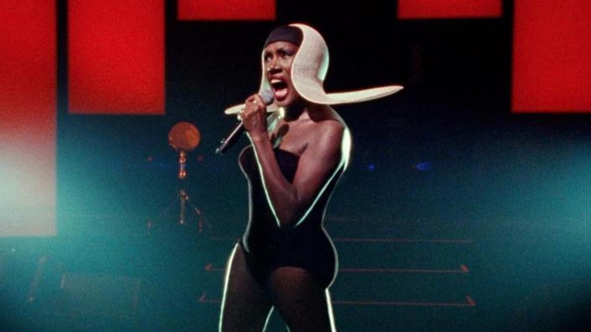 Grace Jones in white futuristic hat.