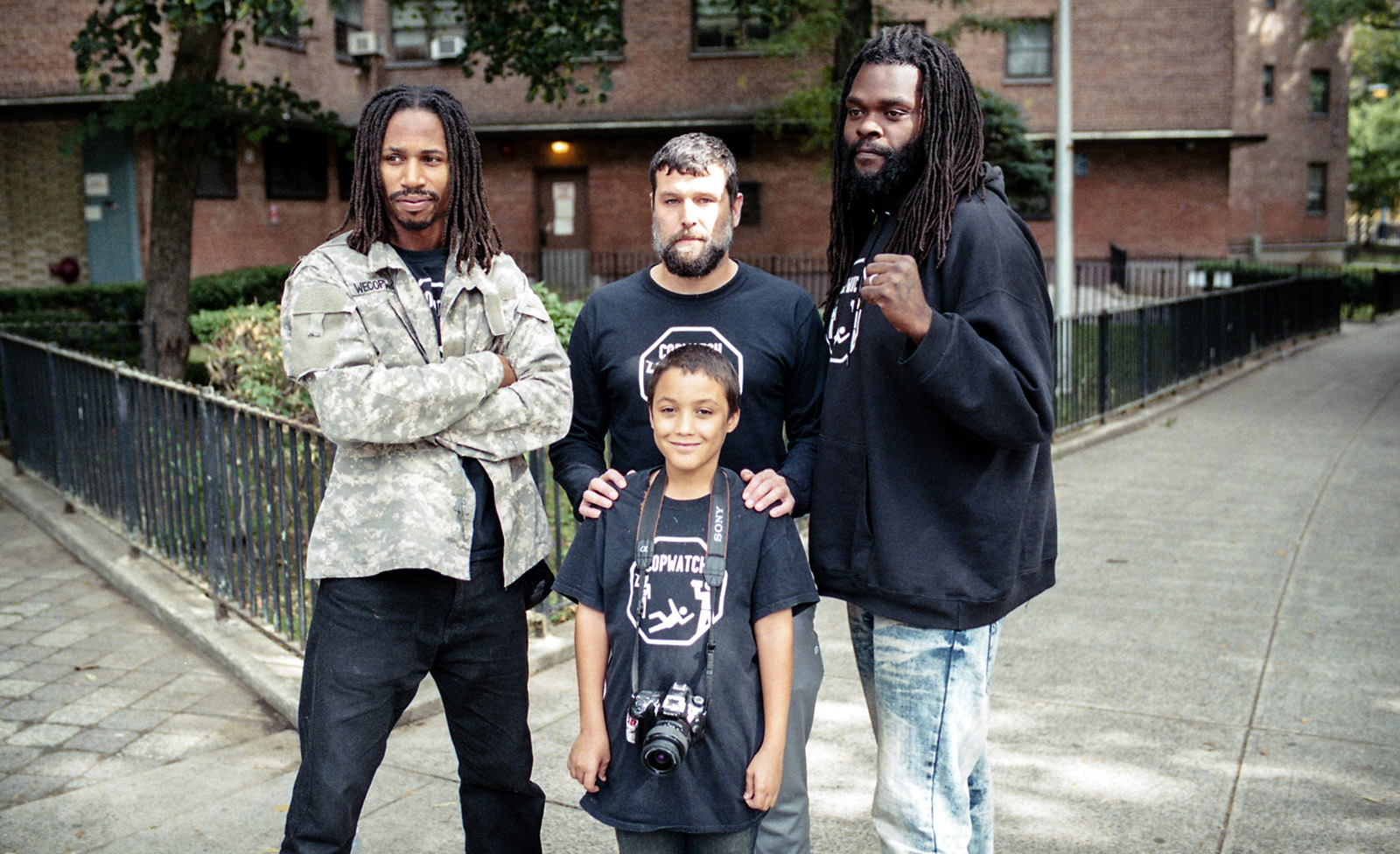 three men and a boy wearing CopWatch t-shirts. CopWatch documentary. Krull magazine interview.