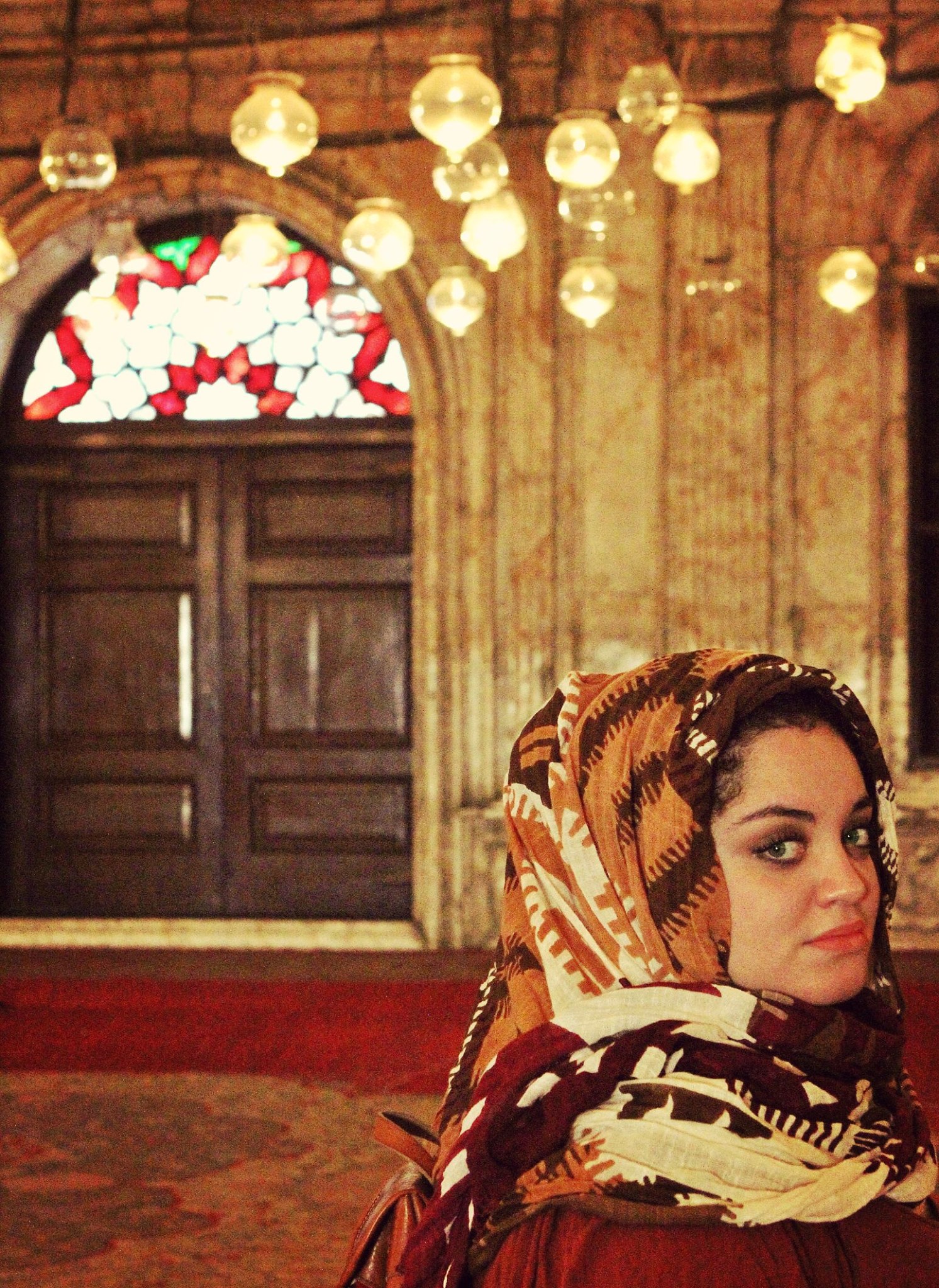 Egyptian woman in head scarf in ornate building
