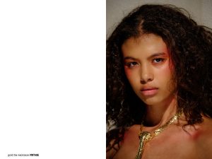model in pink makeup and gold tie necklace