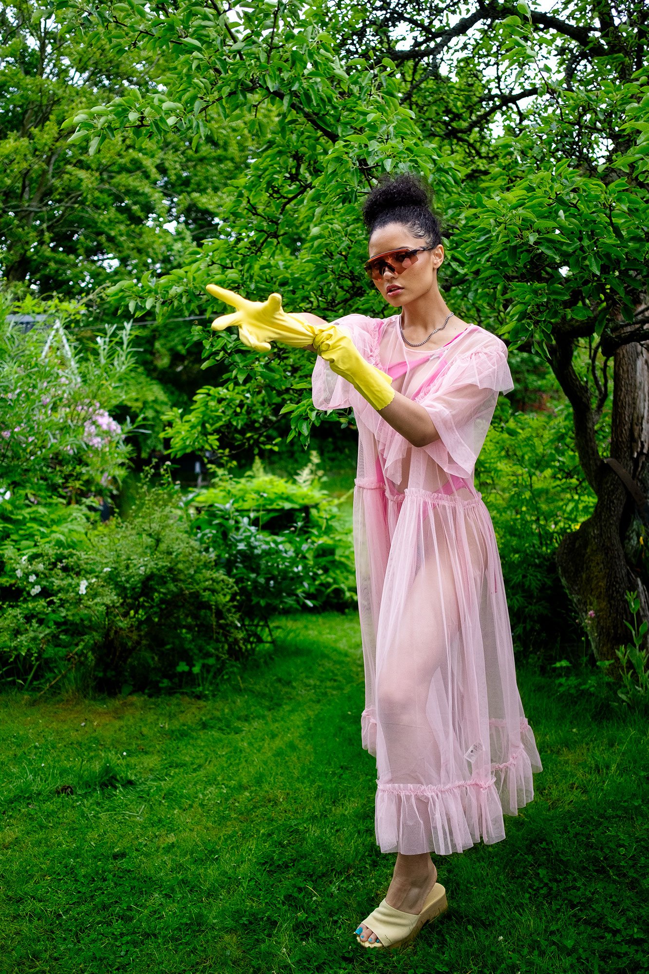 Krull magazine, Gardening Party fashion story, model in garden pink tulle dress over fuschia swimsuit
