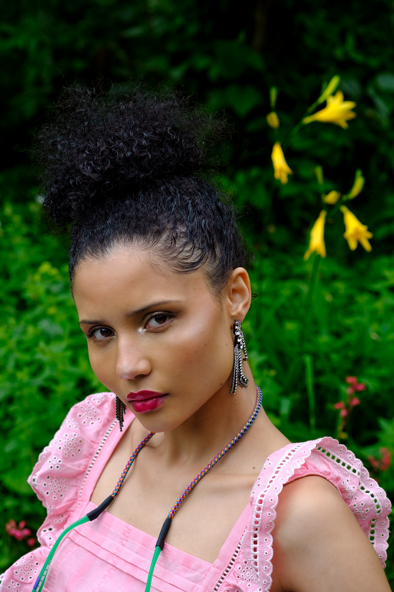 Krull magazine, female model wearing pink lace top in garden