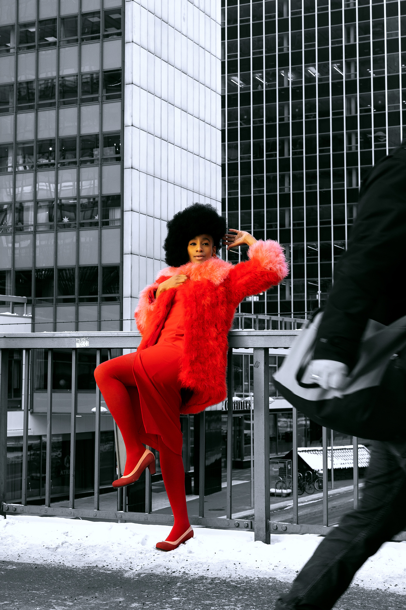 krullmag, shocking red coat against gray cityscape